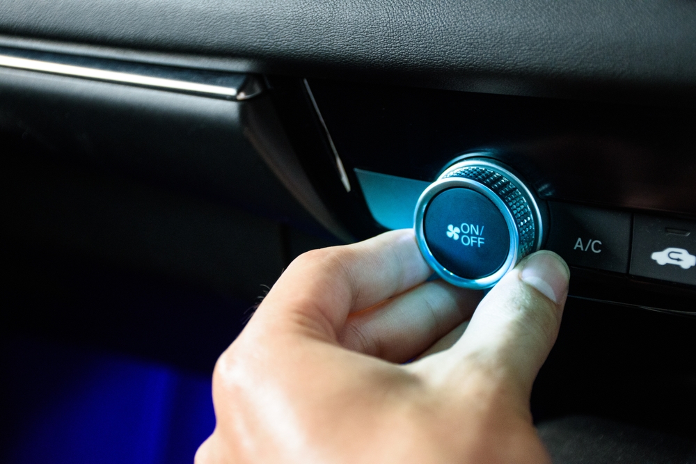 Hand,Turning,The,Button,Car,Air,Conditioning,Fan,To,Air