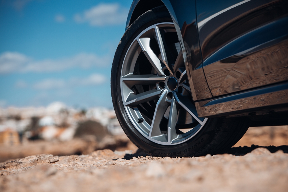 Close-up,View,Of,Wheel,Of,Sports,Car,At,The,Gravel